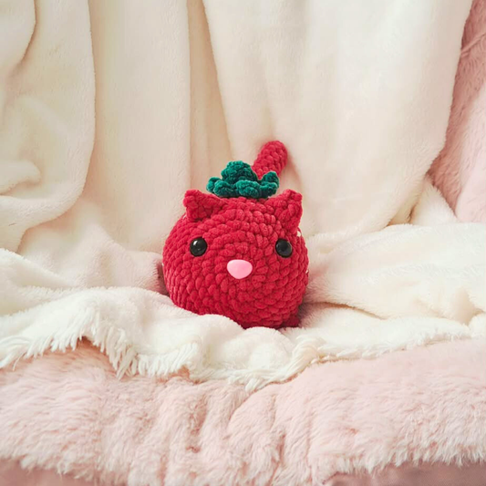 Handmade crochet strawberry loaf cat plush by Chai Rose Crafts, cozy reading companion